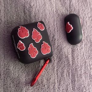 Akatski Apple AirPod case with red keychain piece.